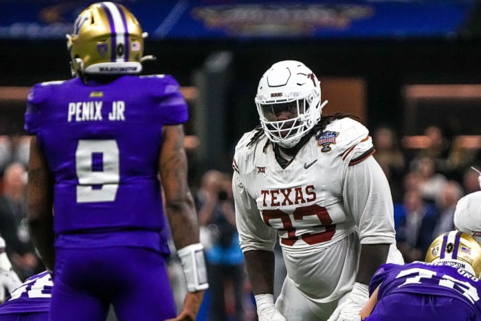Texas Longhorns defensive lineman T'Vondre Sweat (93) watches Washington quarterback Michael Penix Jr. (9) before a snap during the Sugar Bowl College Football Playoff semifinals. © Aaron E. Martinez / USA TODAY NETWORK